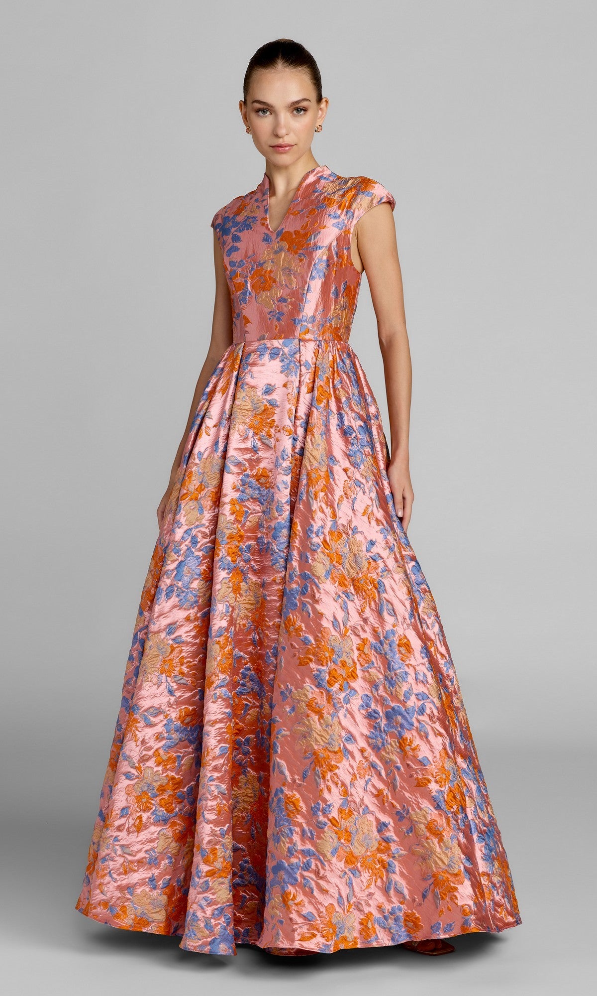 A woman wearing the Mac Duggal 69171 long formal dress in Pink Multi stands against a plain gray background.